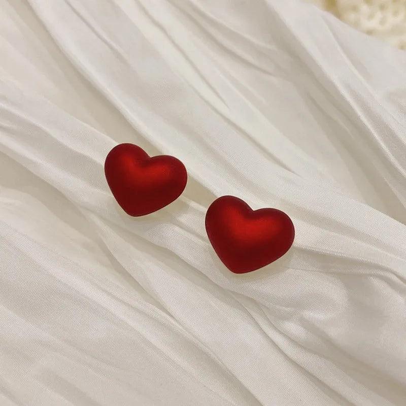 Red heart stud earrings with smooth enamel finish