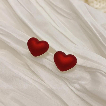 Red heart stud earrings with smooth enamel finish