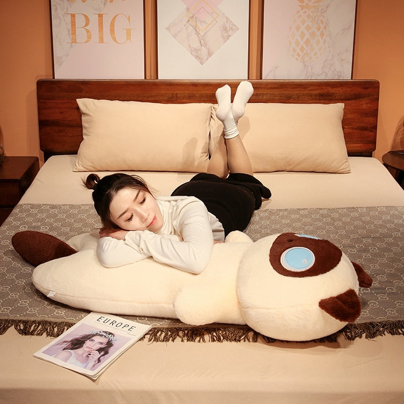 Cream cat plush body pillow with brown ear accents and blue eye patch