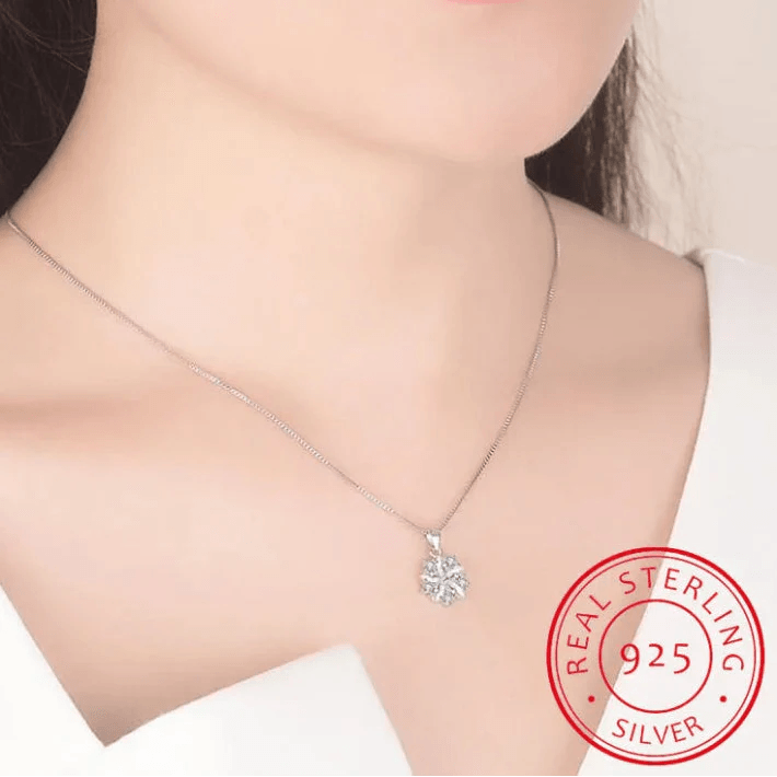 Pink cherry blossom pendant necklace on model's neckline with silver-tone chain