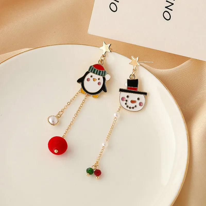 Gold-tone holiday charm drop earrings with penguin heads and red-and-green bead dangles