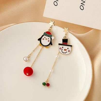 Gold-tone holiday charm drop earrings with penguin heads and red-and-green bead dangles