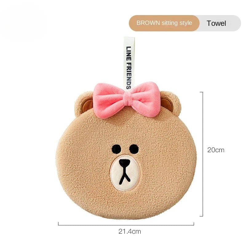Light-brown sitting teddy bear hand towel with pink bow and stitched bear face
