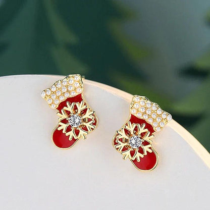Drop earrings with red enamel stockings, gold snowflake detailing, and crystal dangles
