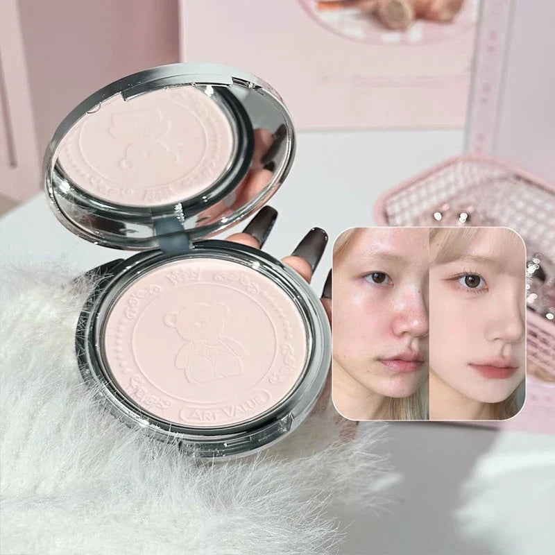 Round bear compact makeup with lid open showing pale powder shades