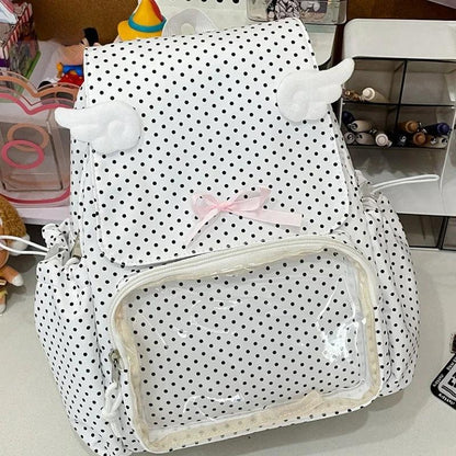 White polka dot backpack with black dots, bow, and transparent front zip pocket