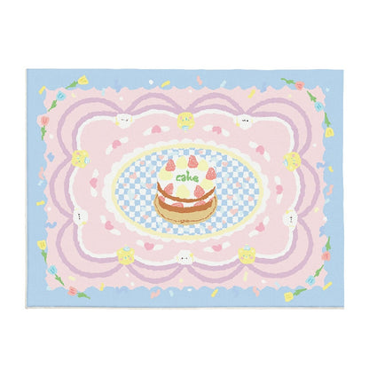 Pastel plush area rug with cake and bunny motifs on light blue