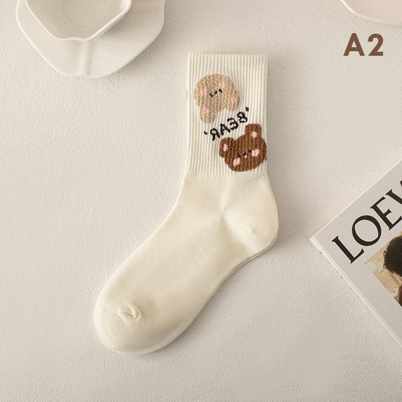Teddy bear socks in white with a pink bear face and a brown bear patch on ankle