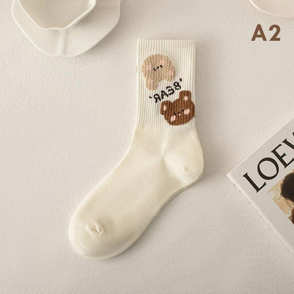Teddy bear socks in white with a pink bear face and a brown bear patch on ankle