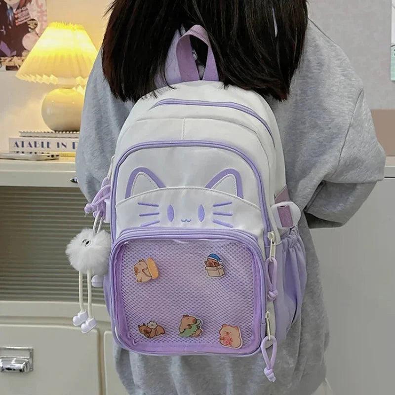 Purple and white cat-face school backpack shown from the back on a person
