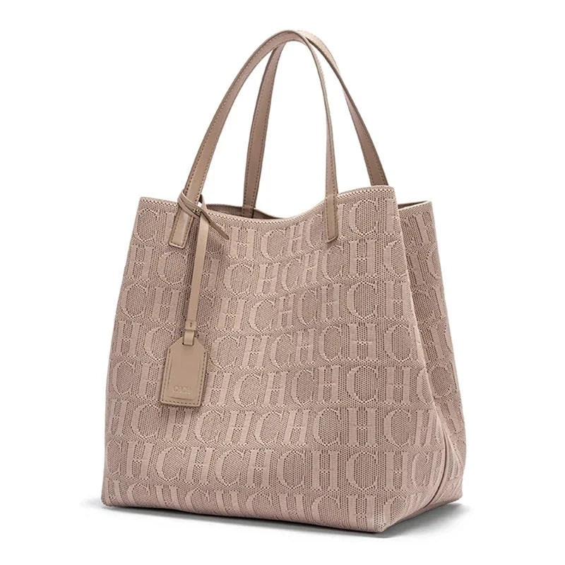 Beige knitted tote bag with embossed CHCH pattern, dual top handles, hanging tag.