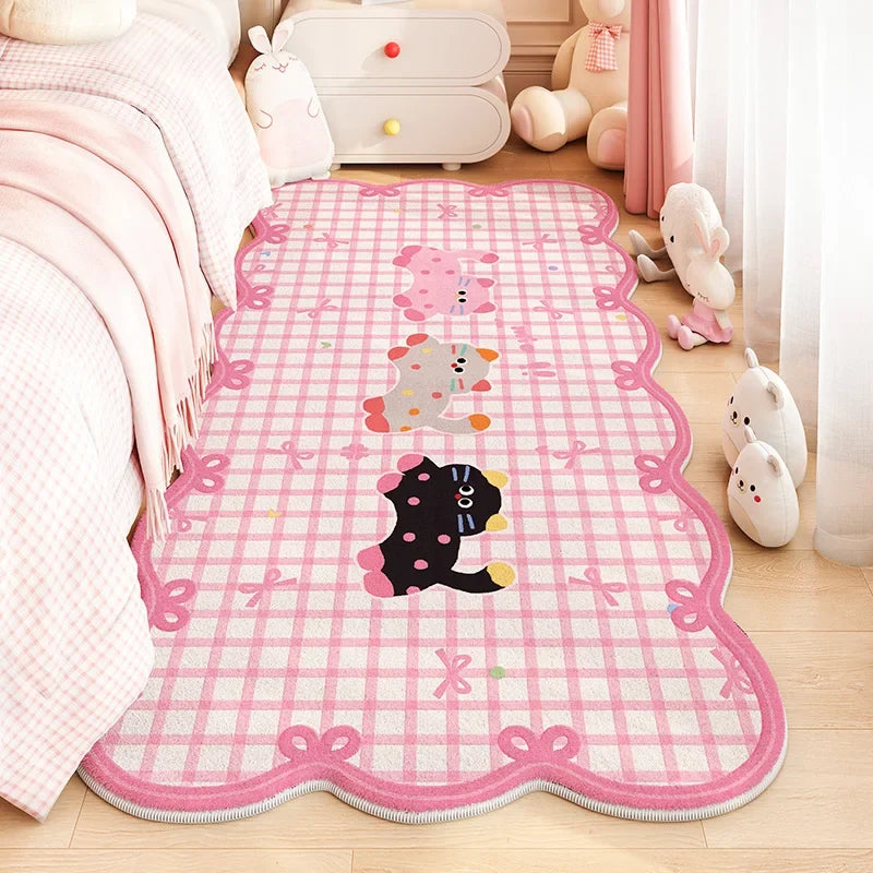 Pink cat area rug with chasing cats and bow border, scalloped edge.