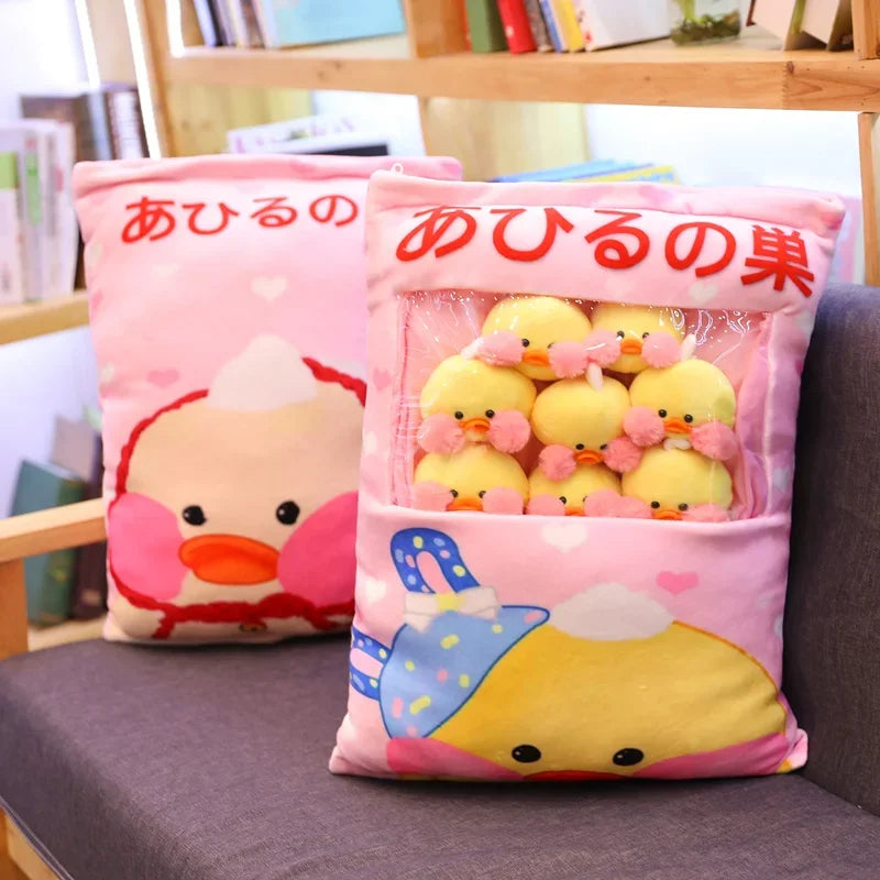 Pink pillow cover with duck illustration and zip-open compartment holding plush ducks