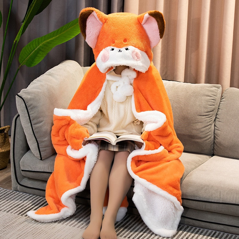 Orange fox blanket hoodie with plush hood and white trim, featuring fox face on front