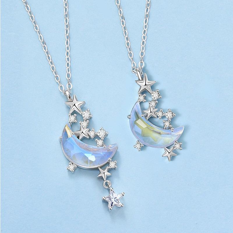 Star-and-moon pendant necklace set with blue iridescent crescent charms and crystal accents