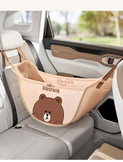 Light brown car seat storage hammock with bear print, hanging straps, and open pouch