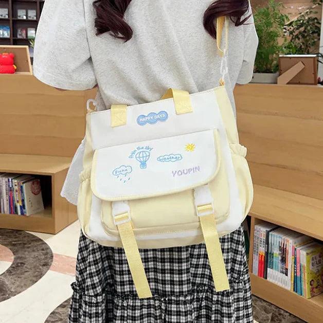 Cream 3-piece backpack set with pale yellow straps and front utility pocket panel