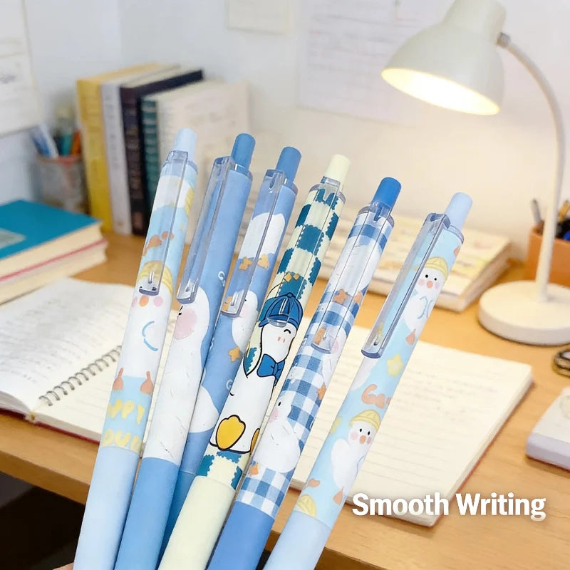 Duck-themed gel pens set with blue caps, clear barrels, cartoon duck artwork on each pen