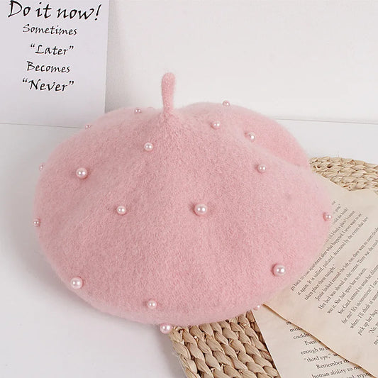 Light pink felt beret with faux pearl dots across the top and small side stem