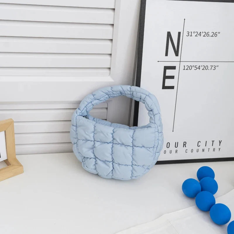 Quilted puffer circle mini bag with top handle, light blue padded nylon.