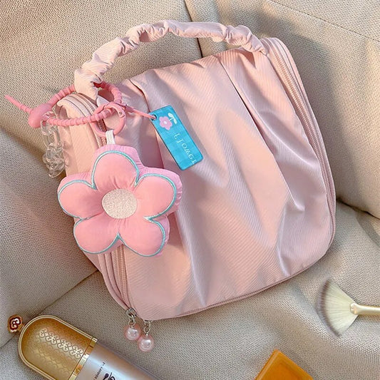 Pink hanging makeup bag with flower pendant charm and zipper, mesh pockets