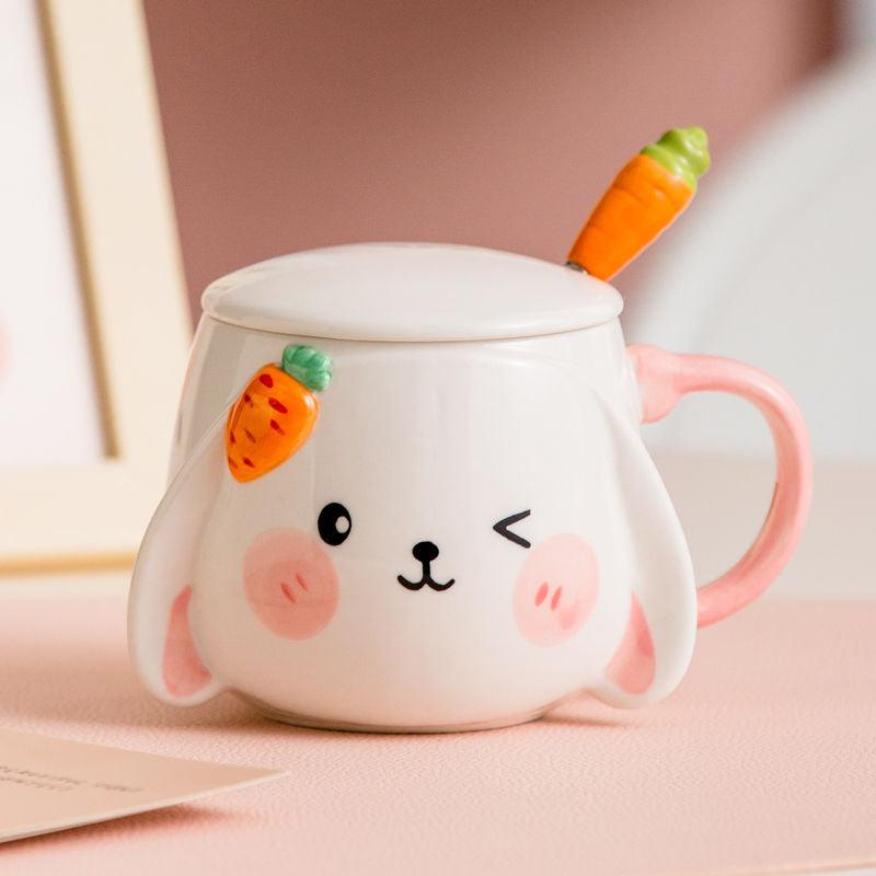 Rabbit ceramic mug with lid and carrot-shaped spoon, pink handle, cute bunny design.