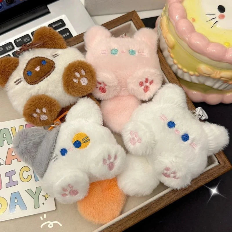 Assorted cat plush keychains: brown, pink, and white cats with metal key rings