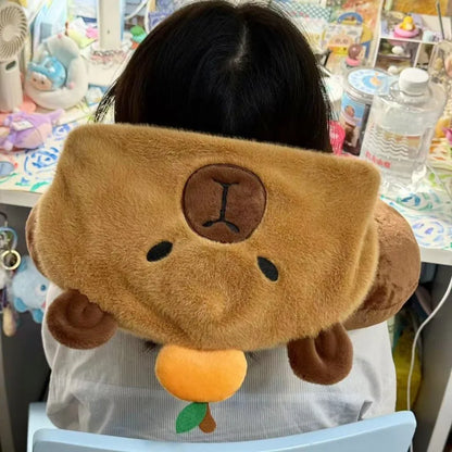 Tan capybara plush neck pillow hat with brown face patch and rounded ears.
