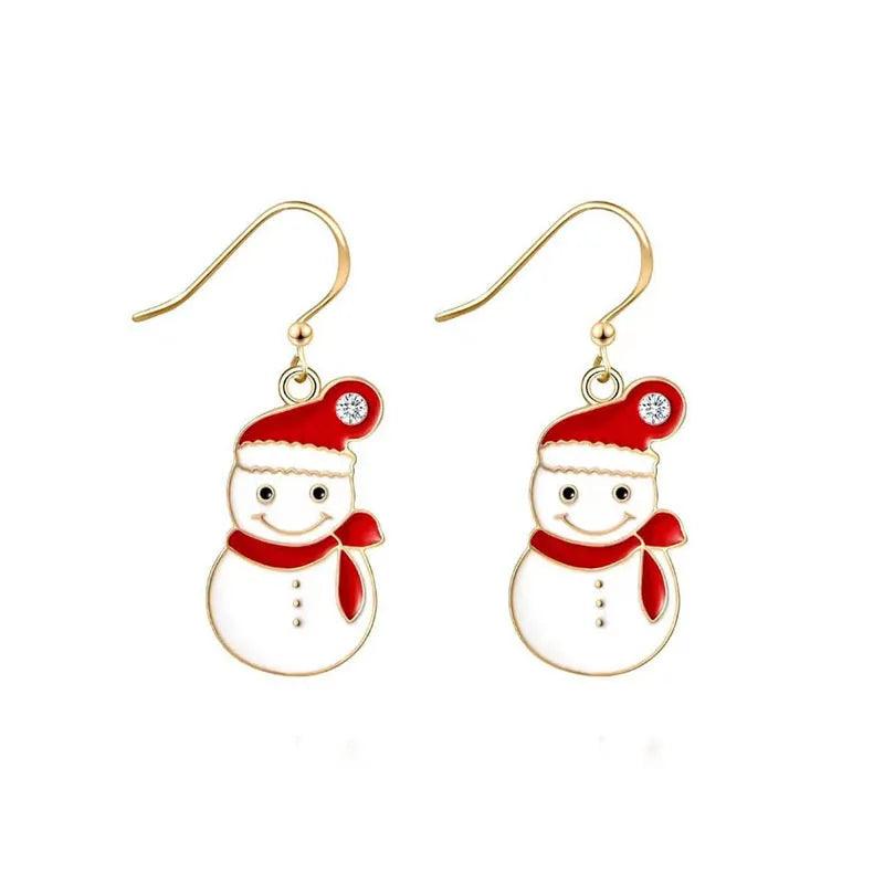 Red heart charm drop earrings with gold hooks, white crystal center, and green tree