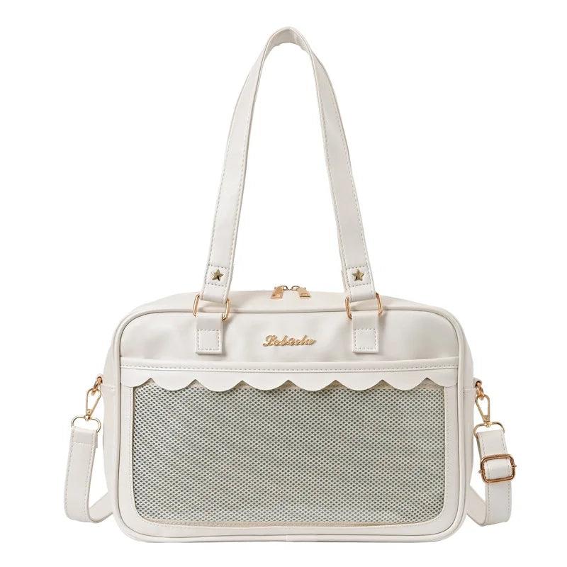 White messenger bag with scalloped top edge and mesh front pocket panel