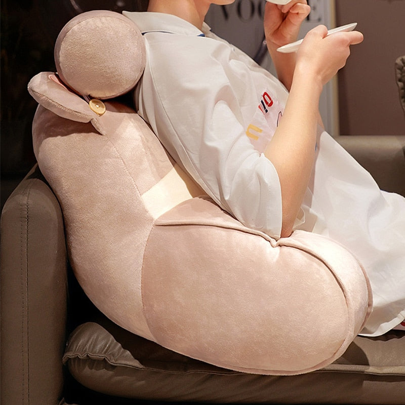 Grey cat reading pillow with plush round head, long arm rest, and button clasp detail