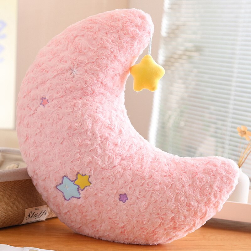 Pink moon plush pillow with yellow star patch and embroidered star accents on side