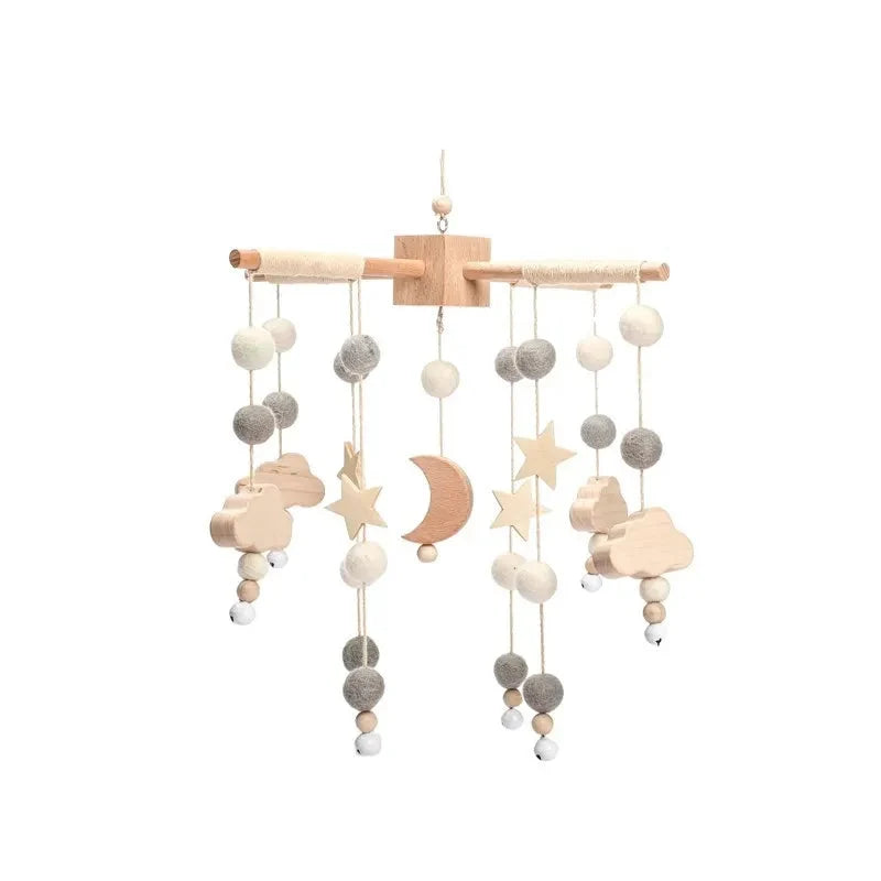 Wooden baby crib mobile with wooden bar and hanging clouds, moons, stars, and beads