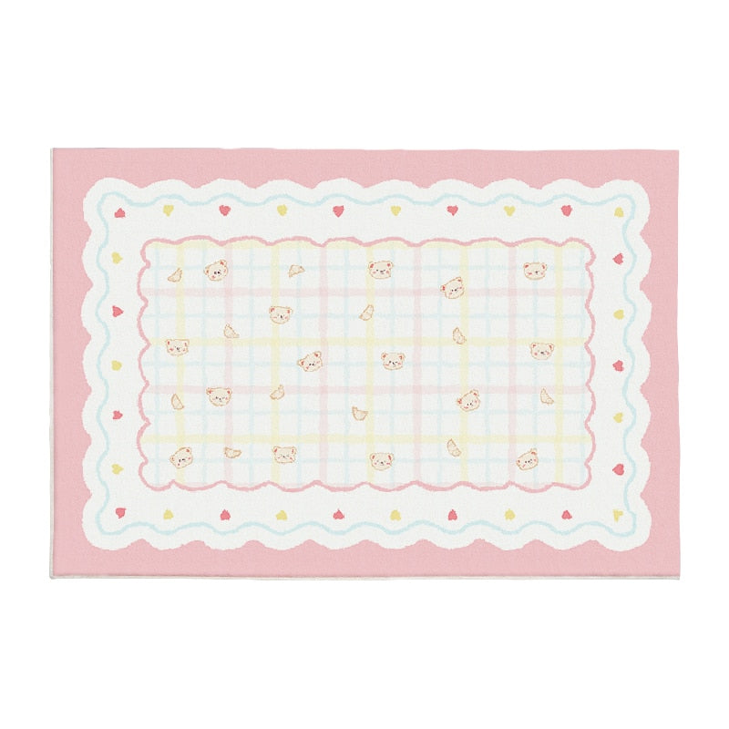 Pink plush area rug with scalloped border, light checker grid, and small bunny faces
