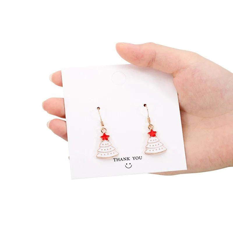 Drop earrings with white Christmas tree charm and red accents on gold hooks