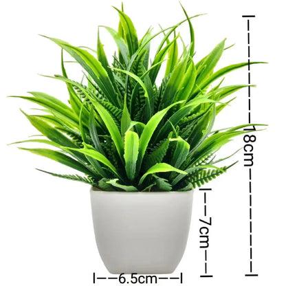 Artificial plant with long green grass blades in a white plastic pot