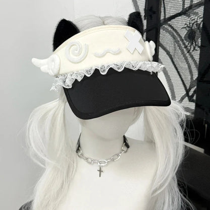 White cat-ear visor with lace trim and crossed patch over brim