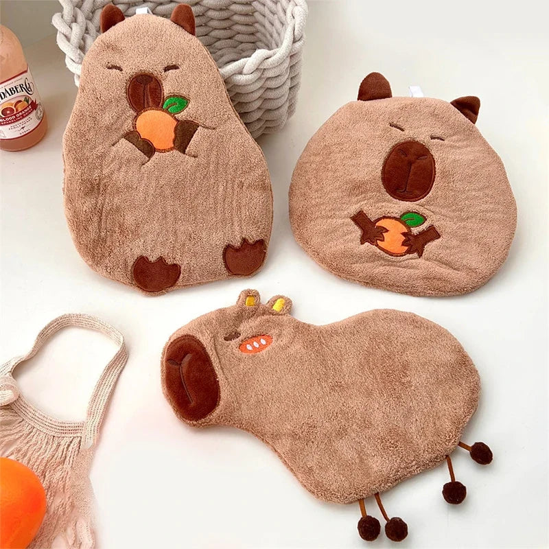 Three capybara cotton hand towels with hanging loops, plush capybara shapes with orange motifs