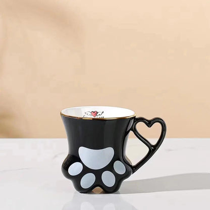 Black cat paw mug with heart-shaped handle and white paw pad pattern