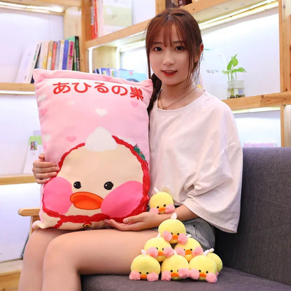 Pink duck pillow with large duck face graphic and a pile of small duck plushies