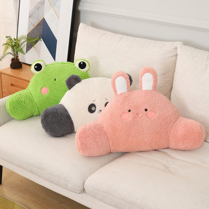 Plush animal cushions on a sofa: green frog, panda, and pink bunny pillows.