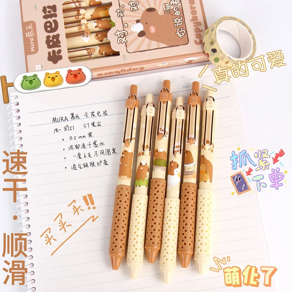 Capybara gel pens standing on paper, patterned barrels and dotted grip sections