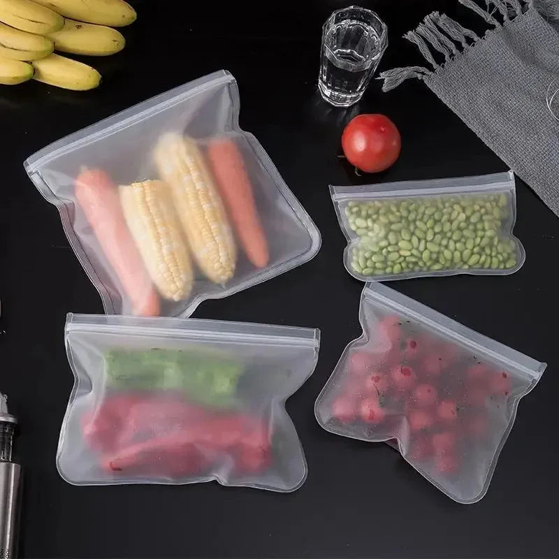 Silicone storage bag set with clear zip tops, filled with assorted vegetables and fruit