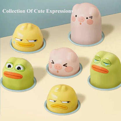 Collection of smiling animal shape puzzle bases: duck, frog, and pig on display