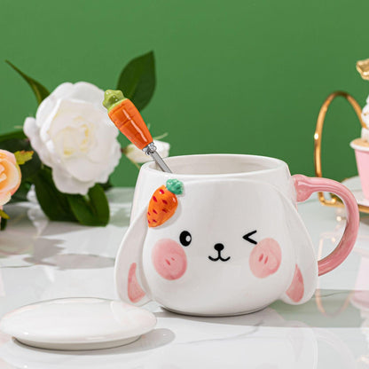 Rabbit ceramic lidded mug with carrot spoon, pink handle, bunny face decoration.