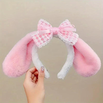 Plush bunny ear headband with pink ears, white trim, and pink patterned lace bow.