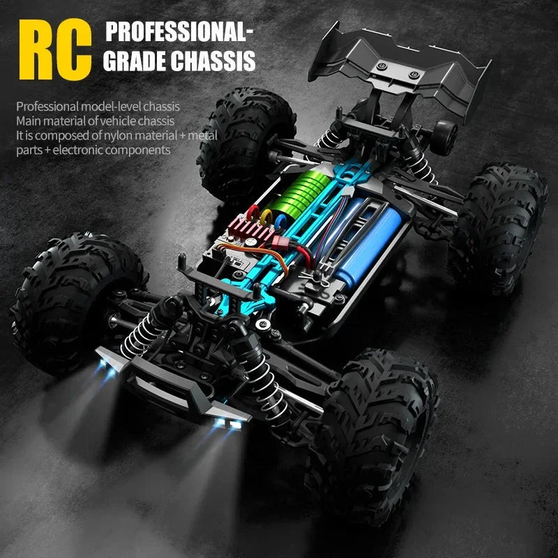 RC monster truck chassis with green motor, blue frame, suspension and large tires