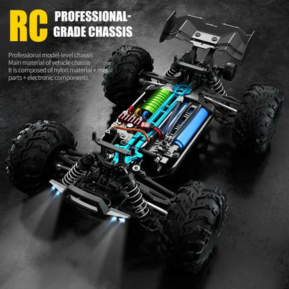 RC monster truck chassis with green motor, blue frame, suspension and large tires