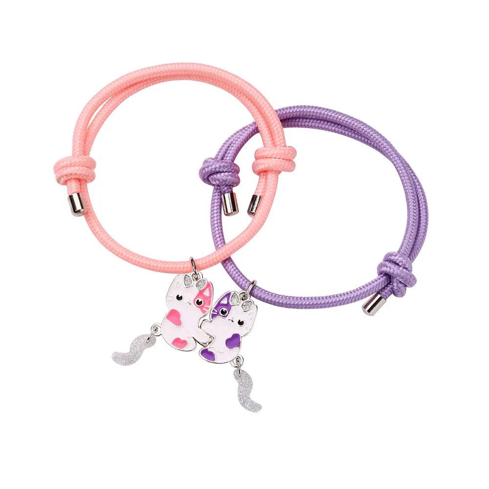 Braided friendship bracelets with pink and purple bands, two cat charms, and silver connector beads