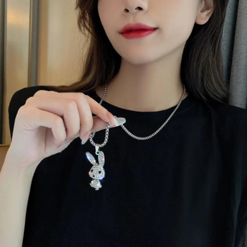 Rhinestone bunny pendant necklace worn on a neckline with small rabbit charm
